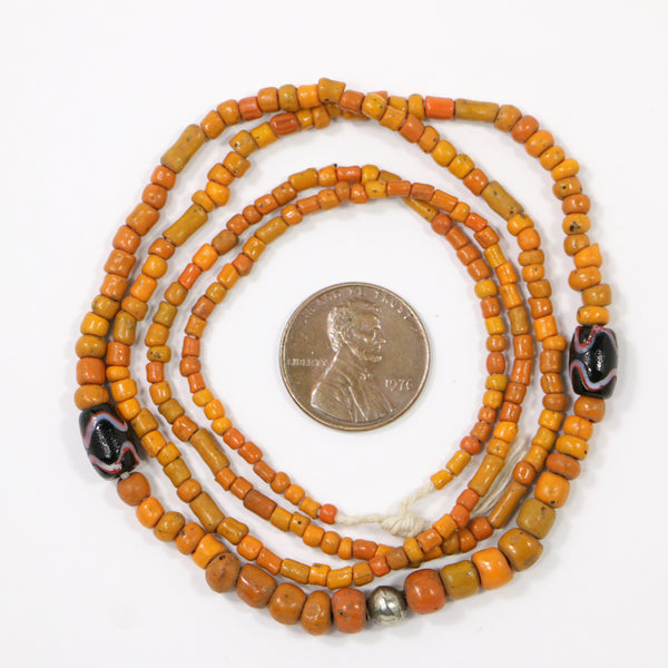 Indonesia, Orange Antiqued Seed Beads 2-4mm with 2 Small Black Beads on 24-inch Strands