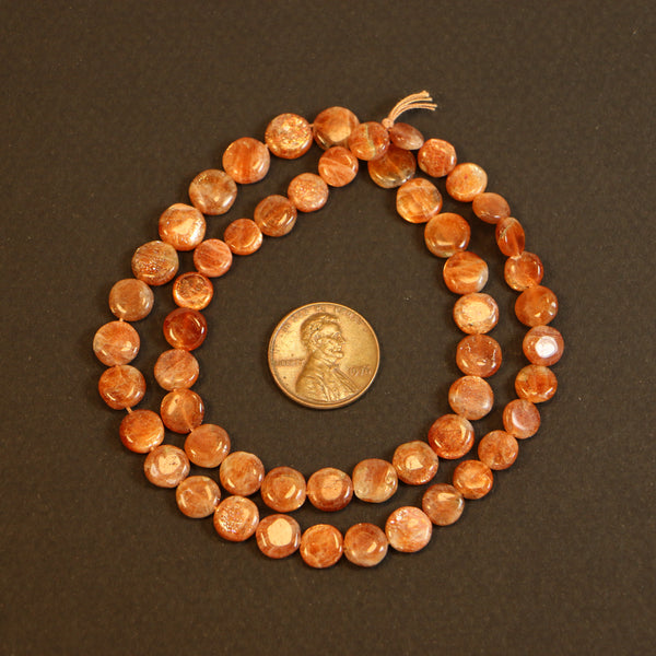 Sunstone, Coin Shape on Very Slightly Graduated 16-inch Strand, Beads 6-8mm Diameter
