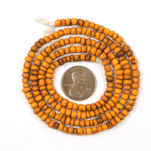 Indonesia, Orange Antiqued Seed Beads 4mm Diameter on 23-inch Strands