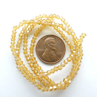 Faceted Glass "Dragon Crystal" 2x2mm, Light Amber with Light AB Finish