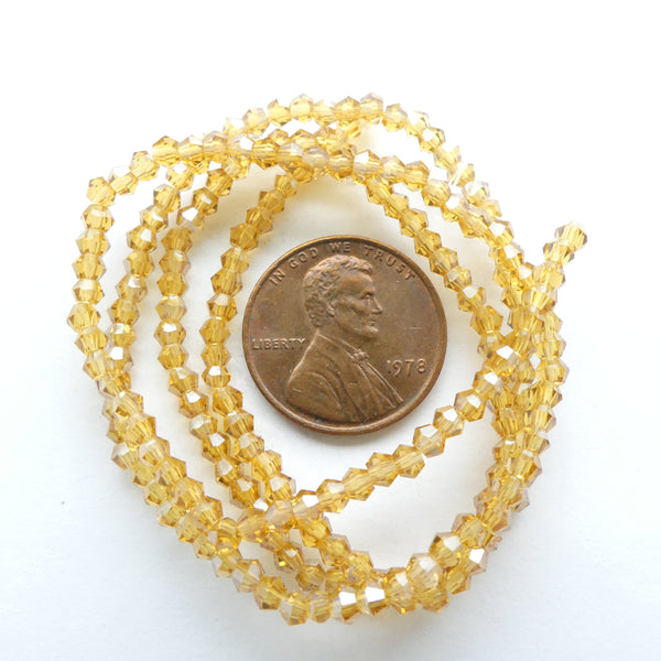 Faceted Glass "Dragon Crystal" 2x2mm, Light Amber with Light AB Finish