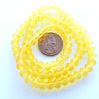 Faceted Glass "Dragon Crystal" 4x6mm, Translucent Yellow, 16-inch Strands